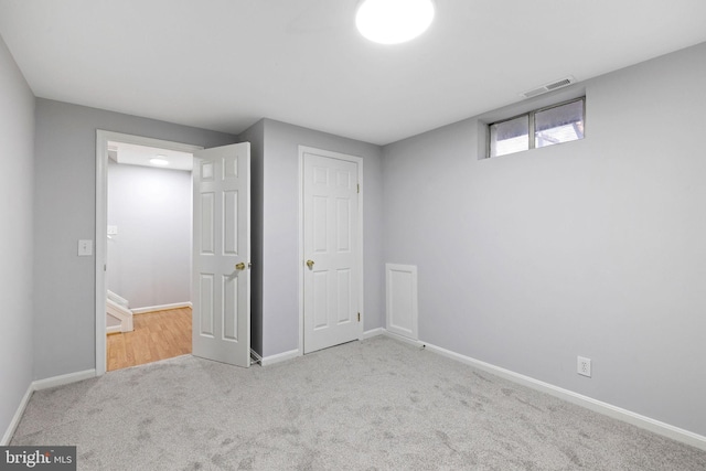 unfurnished bedroom with visible vents, baseboards, and carpet