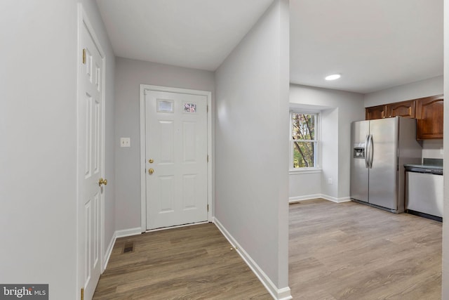interior space with light wood-style floors and baseboards