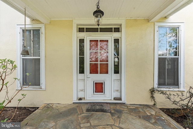 property entrance with stucco siding