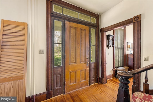 entrance foyer featuring baseboards and wood finished floors
