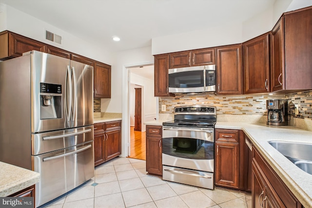 3430 Valewood Dr, Oakton, VA 22124 - kitchen featuring tasteful backsplash, light tile patterned floors, light countertops, visible vents, and appliances with stainless steel finishes
