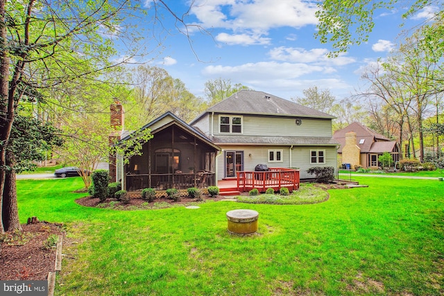 3430 Valewood Dr, Oakton, VA 22124 - back of property with a sunroom, a yard, a wooden deck, and a chimney