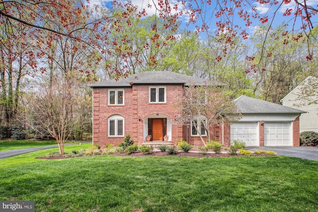 3430 Valewood Dr, Oakton, VA 22124 - colonial-style house with a front yard, an attached garage, brick siding, and aphalt driveway