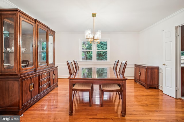 3430 Valewood Dr, Oakton, VA 22124 - dining room featuring a decorative wall, light wood-style flooring, ornamental molding, a wainscoted wall, and a notable chandelier