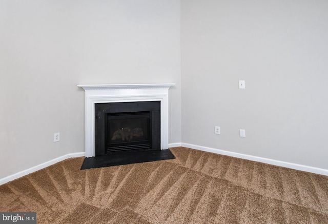 interior details with a fireplace with flush hearth, baseboards, and carpet flooring