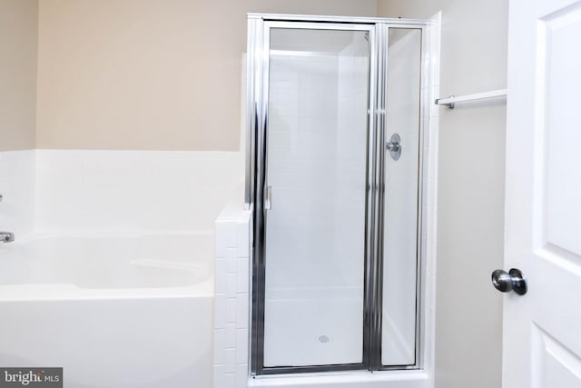 full bath featuring a shower stall and a bath