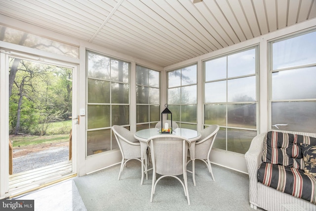 sunroom featuring outdoor dining area