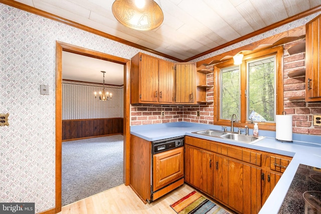 kitchen with paneled dishwasher, wallpapered walls, ornamental molding, and a sink
