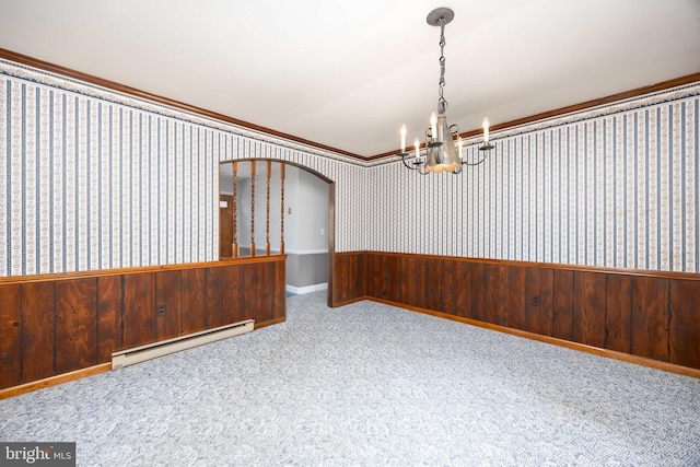 carpeted empty room featuring ornamental molding, wallpapered walls, arched walkways, a baseboard radiator, and a notable chandelier