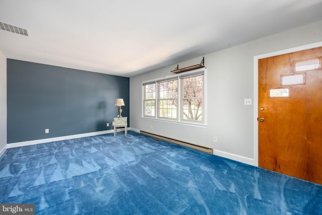 empty room with baseboards, carpet, baseboard heating, and visible vents