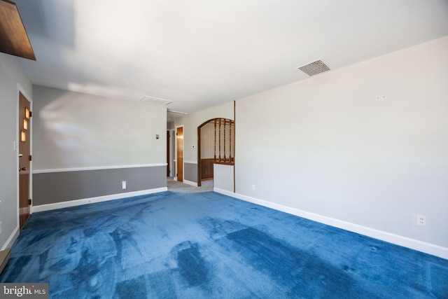 carpeted empty room with visible vents and baseboards