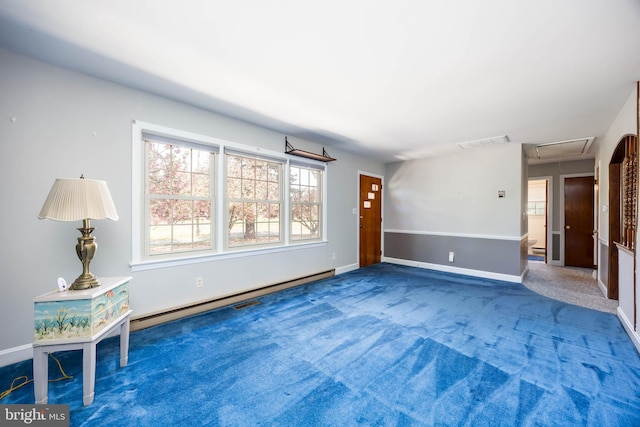 unfurnished living room with baseboard heating, carpet floors, attic access, baseboards, and visible vents