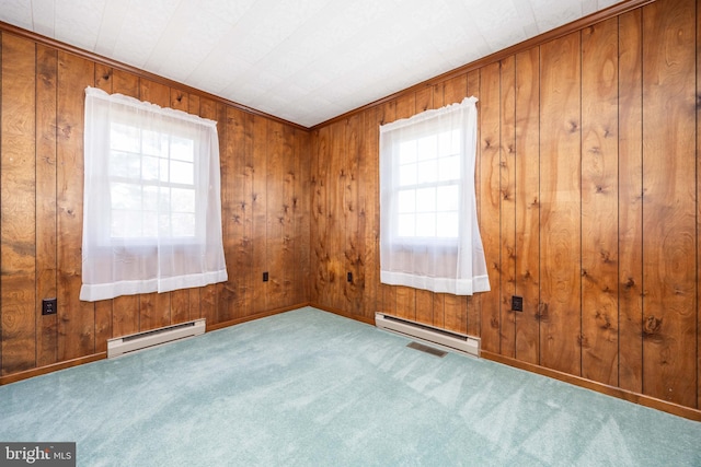 spare room with plenty of natural light, a baseboard radiator, and carpet flooring
