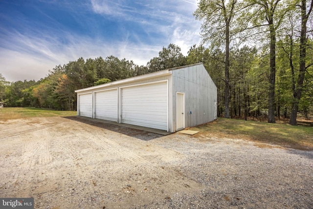 detached garage featuring a wooded view