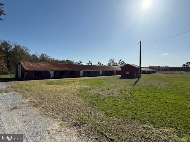 view of front facade with an outbuilding and a front yard
