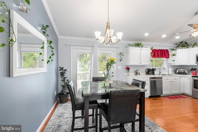 dining area with ceiling fan with notable chandelier, crown molding, light wood-style floors, and recessed lighting