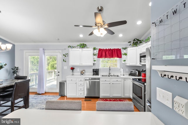 kitchen featuring open shelves, stainless steel appliances, light wood-type flooring, and a sink