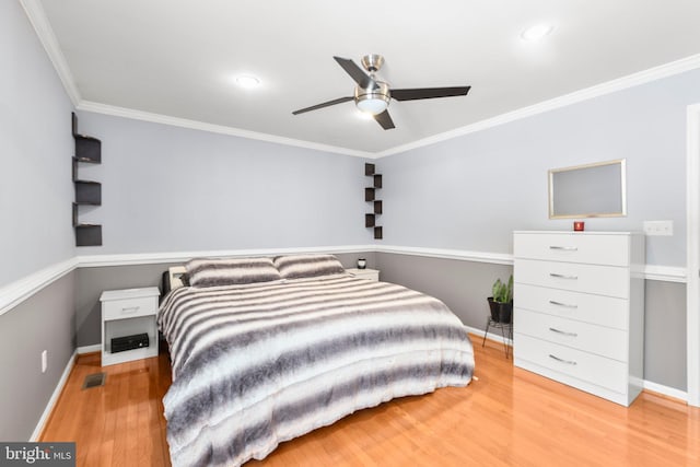 bedroom with wood finished floors, baseboards, ornamental molding, visible vents, and recessed lighting
