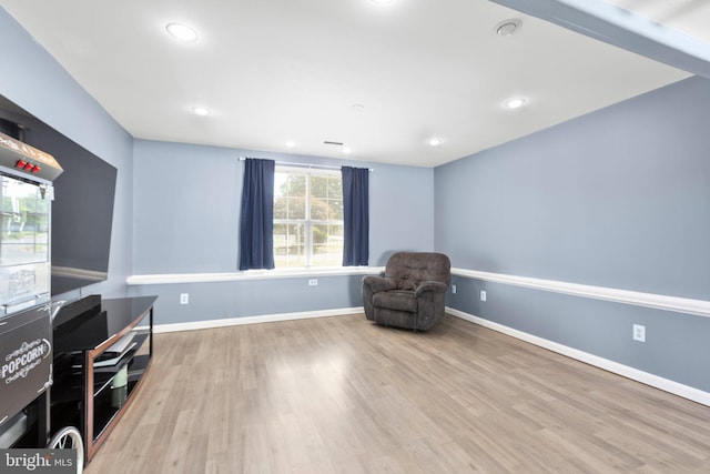 unfurnished room featuring recessed lighting, wood finished floors, and baseboards