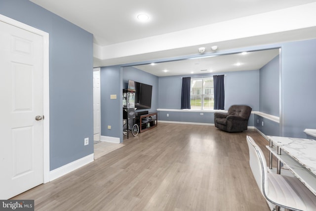 sitting room featuring light wood-type flooring and baseboards