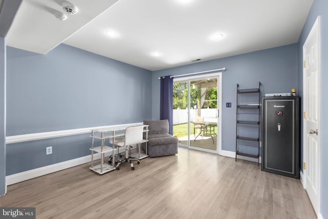 sitting room with baseboards, wood finished floors, and recessed lighting