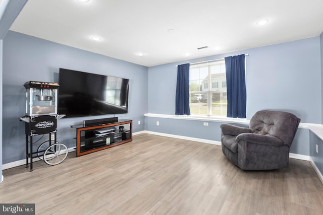 sitting room with visible vents, baseboards, wood finished floors, and recessed lighting