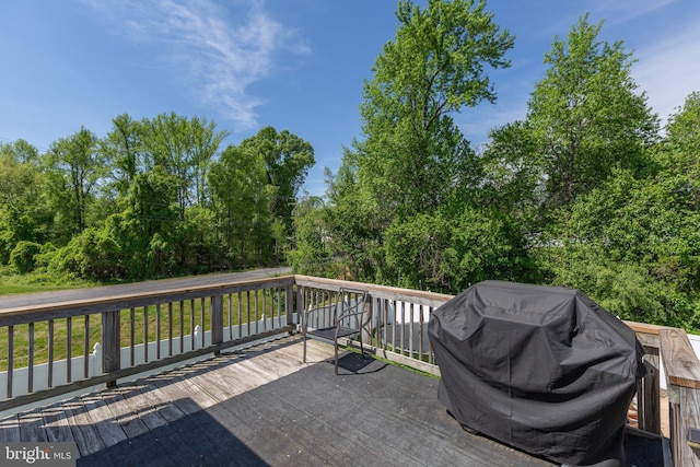 wooden deck featuring a grill