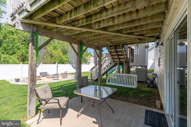 view of patio with stairway, a fenced backyard, and a fire pit