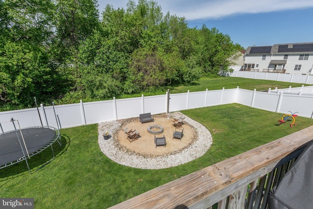 view of yard with a trampoline, a patio, and a fenced backyard