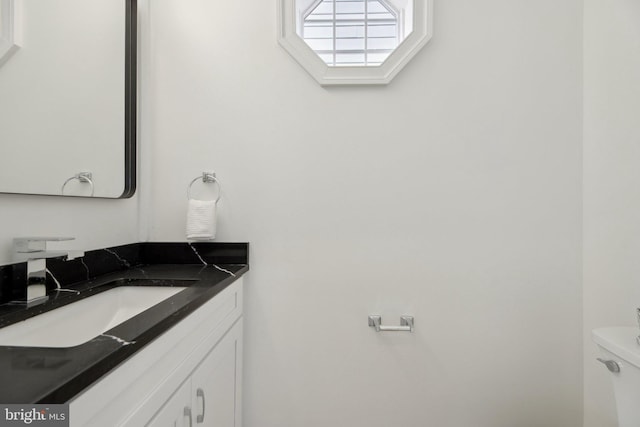 half bath with vanity and toilet