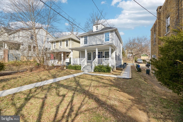 traditional style home featuring a front lawn and covered porch