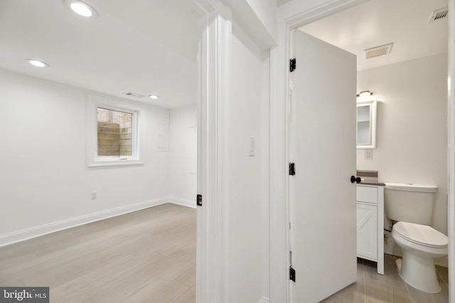 bathroom with visible vents, toilet, recessed lighting, vanity, and wood finished floors