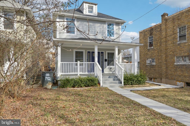 traditional style home with a front yard and a porch