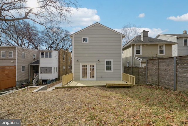 rear view of house featuring french doors, fence, and a wooden deck