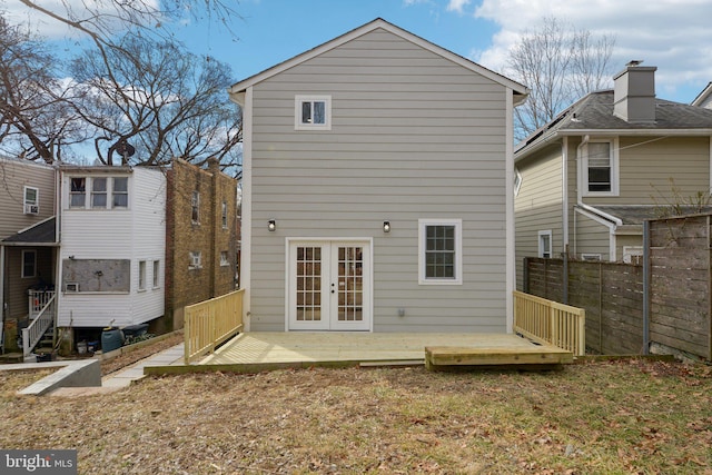 back of house with french doors, a wooden deck, and fence