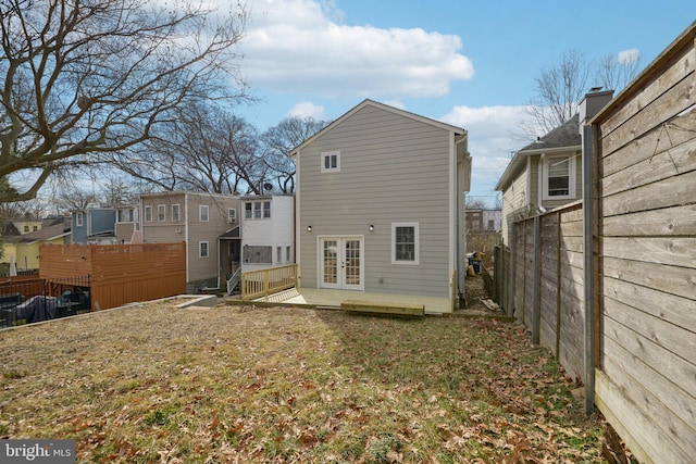 rear view of house with french doors and fence