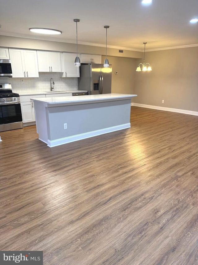 7553 Spring Lake Dr Unit 7553-D, Bethesda, MD 20817 - kitchen featuring ornamental molding, white cabinetry, backsplash, appliances with stainless steel finishes, and a sink