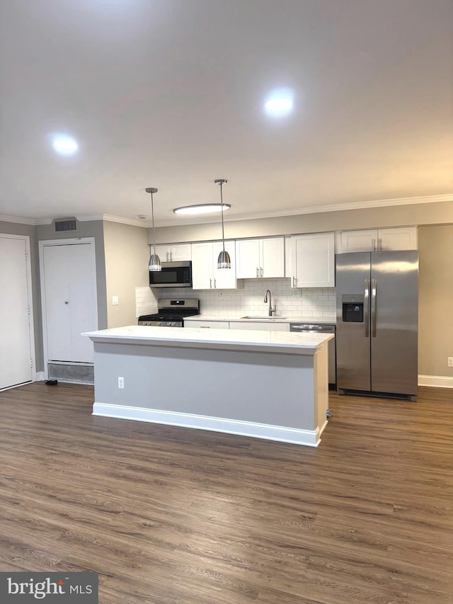 7553 Spring Lake Dr Unit 7553-D, Bethesda, MD 20817 - kitchen featuring dark wood-style flooring, a sink, ornamental molding, and stainless steel appliances