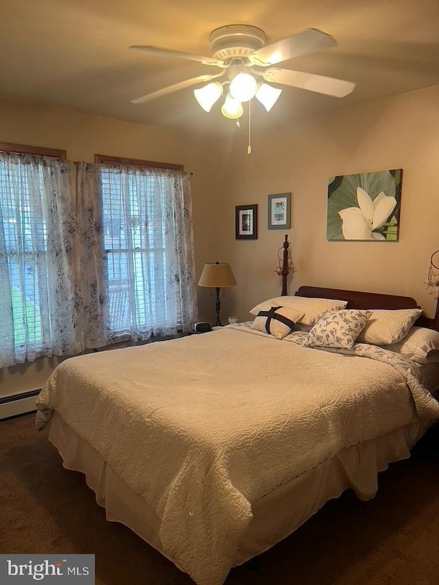 bedroom with a ceiling fan and a baseboard radiator