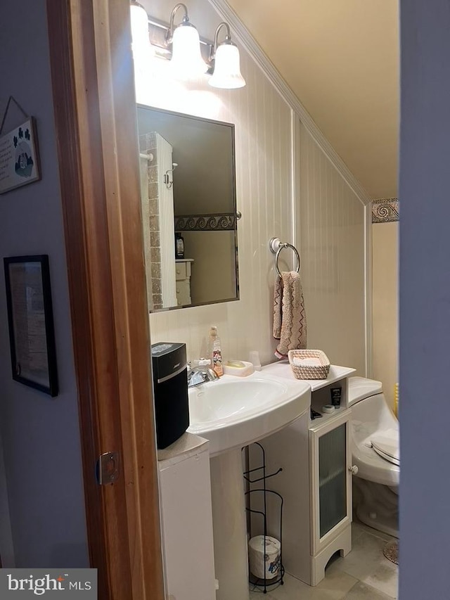 bathroom featuring toilet and tile patterned flooring