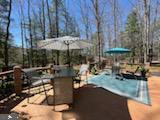 view of swimming pool featuring a swimming pool and a deck