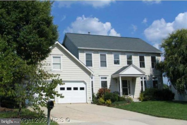 colonial home with a garage and driveway