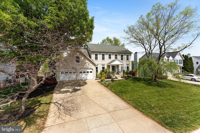 colonial inspired home featuring a front yard, driveway, and an attached garage