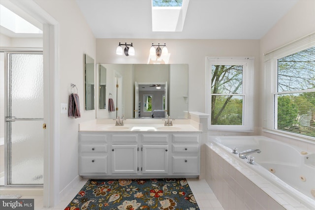 full bathroom featuring double vanity, a sink, a whirlpool tub, and a skylight