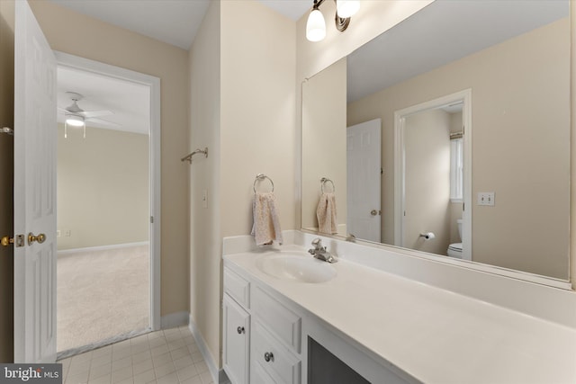 bathroom with ceiling fan, baseboards, toilet, tile patterned floors, and vanity