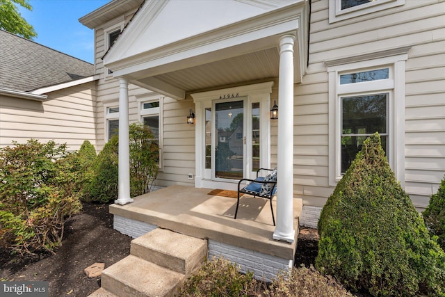 view of exterior entry featuring a porch