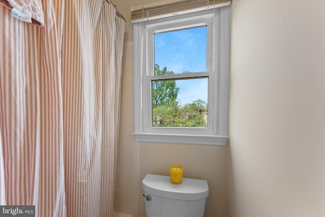 bathroom featuring toilet and a shower with curtain