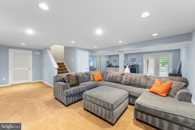 living area featuring stairway, french doors, light colored carpet, and recessed lighting