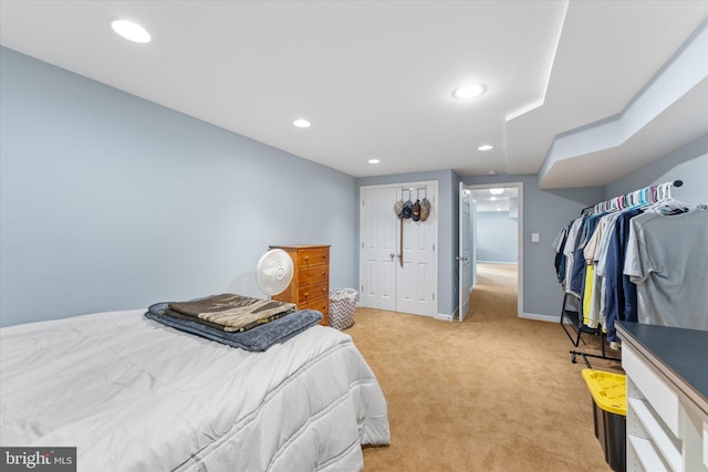bedroom featuring recessed lighting, a closet, light colored carpet, and baseboards