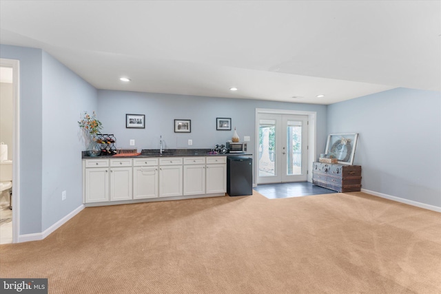 bar with stainless steel microwave, recessed lighting, indoor wet bar, light carpet, and black dishwasher